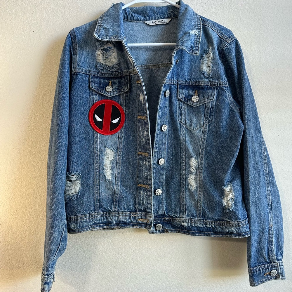 Woman’s Denim Jacket with “Dead Pool”Patch distressed- tear grunge